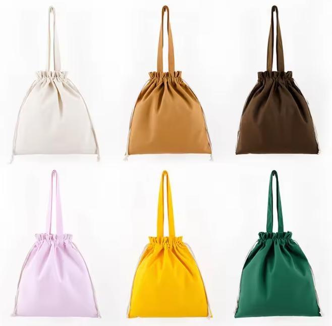 Durable, washable cotton drawstring bag with a handle and an artistic, laid-back vibe